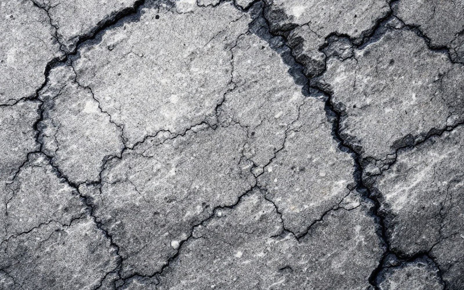 A granite quarry face with drill marks in the stone