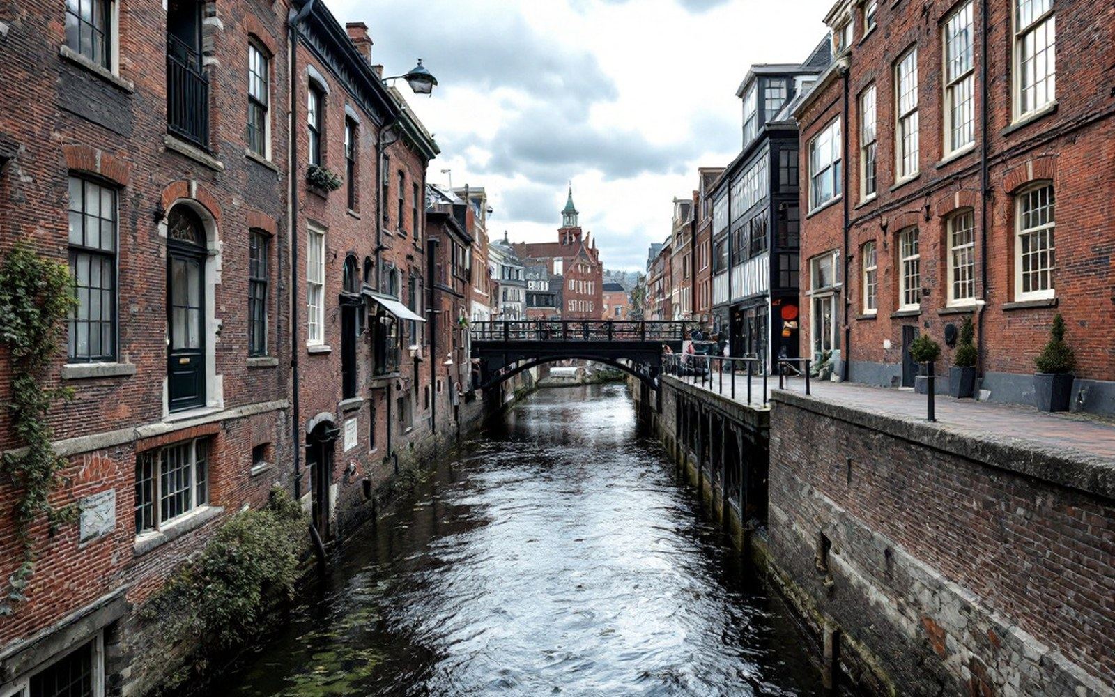 A channel of water passing under a modern walkway