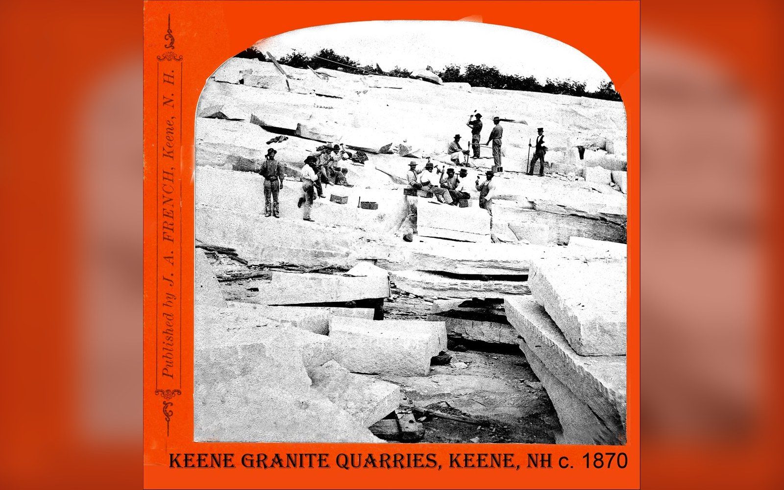 Workers pose among cut granite blocks in an old quarry photograph