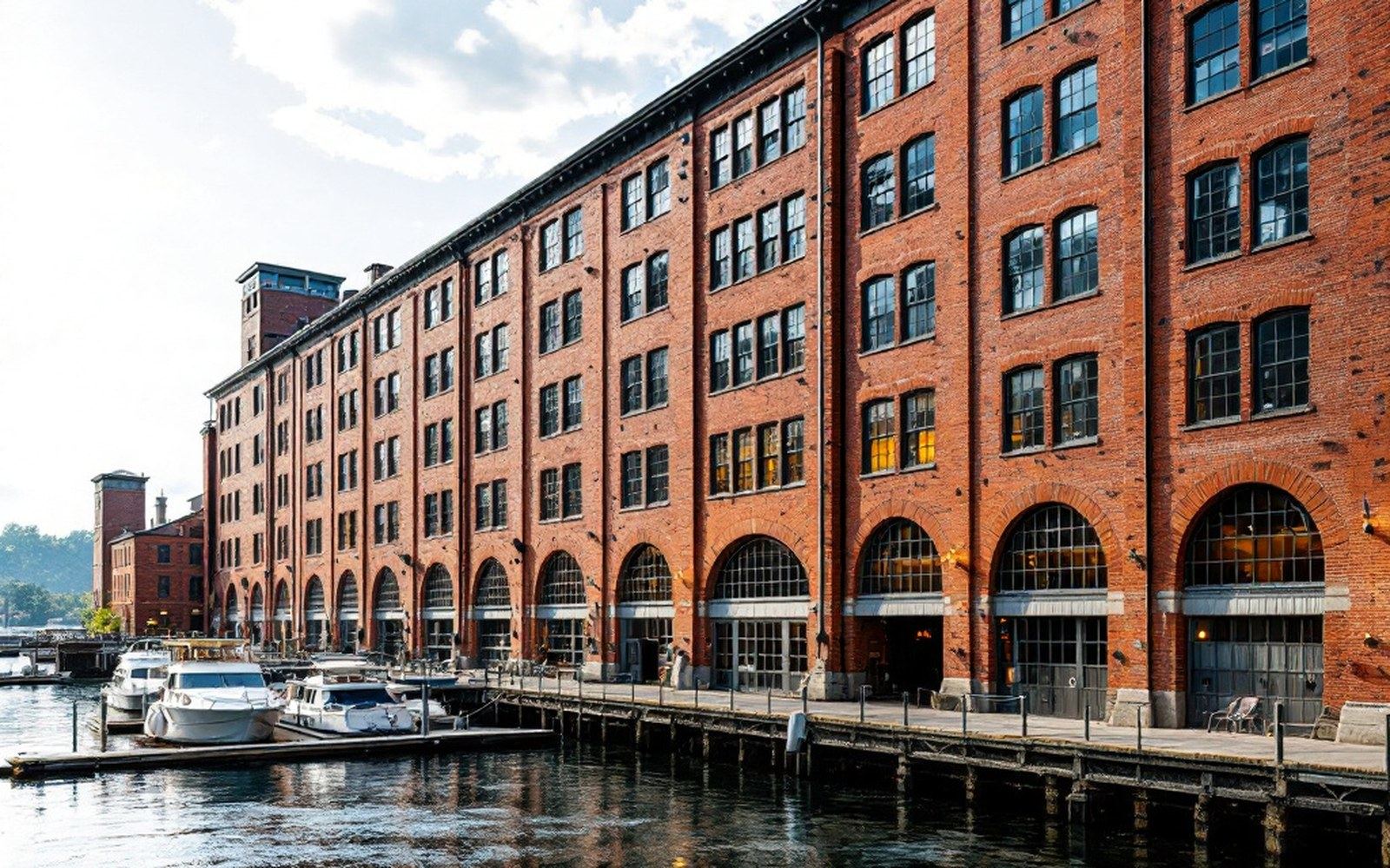 A long brick mill facade with regular window bays